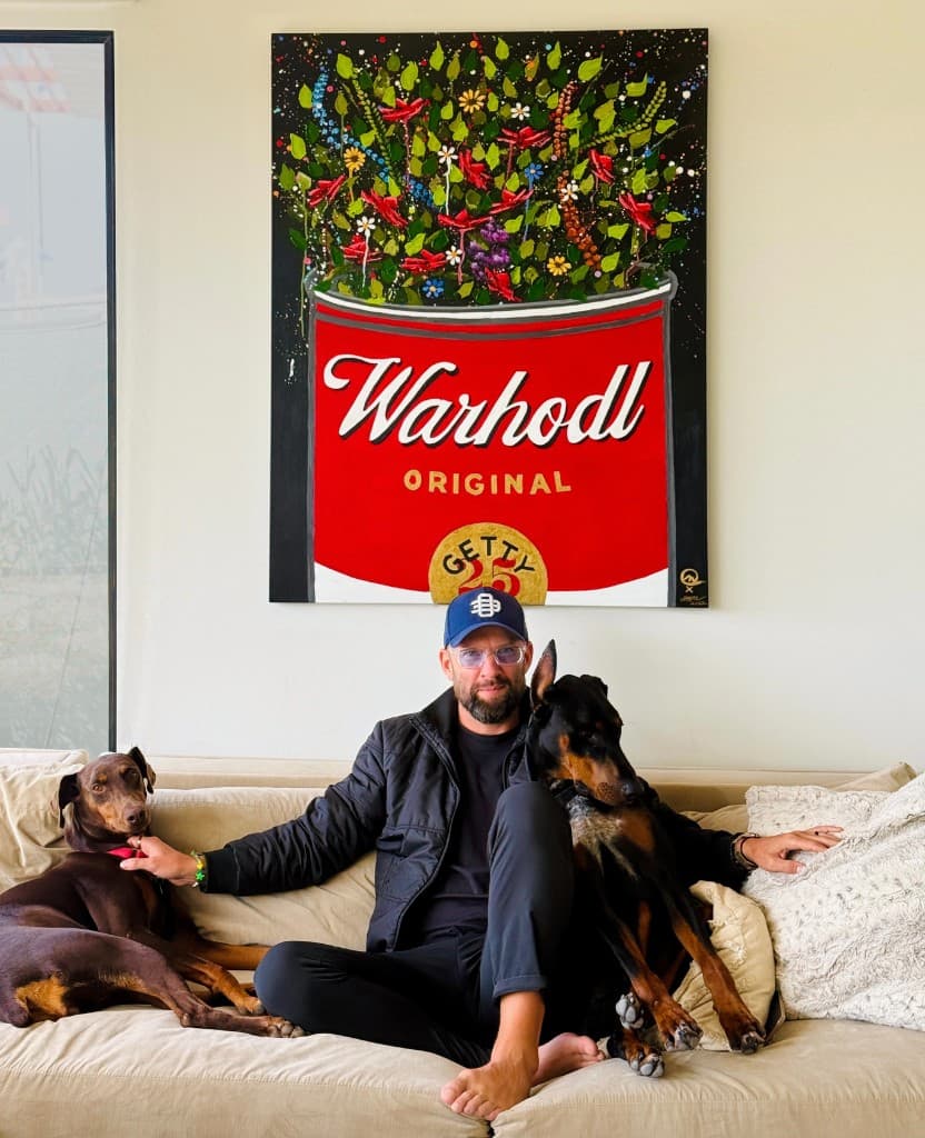 Taylor Good with his Dobermans in front of a WARHODL original painting for the Getty Museum